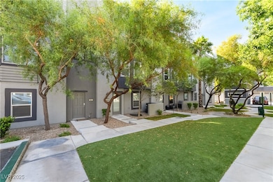 View of front facade with a front yard and stucco