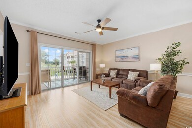 Living room featuring crown molding, light hardwoo