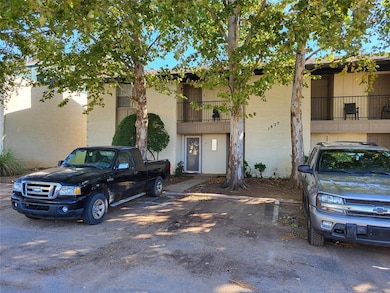 View of building exterior featuring uncovered parking