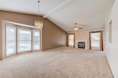 The great room has a side bay window and gas firep