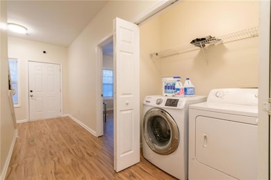 Washroom featuring separate washer and dryer, a we