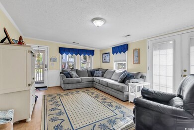 Living room featuring a textured ceiling, ornament