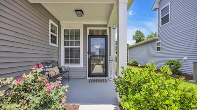View of exterior entry with covered porch