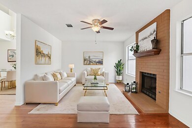 Living area featuring ceiling fan, wood finished 