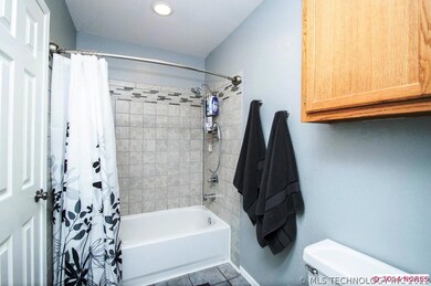 This updated bath/showerin soft, warm greys, separ