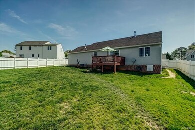 Deck overlooks a large yard.  Deck is treated with