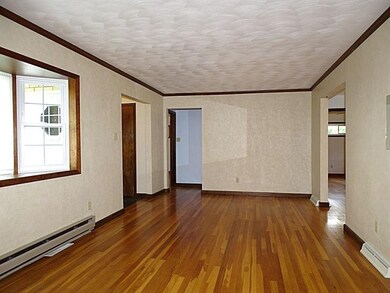 Gleaming hardwood floor and framed in stained crow