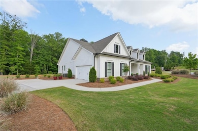 View of home's exterior featuring a garage, a lawn