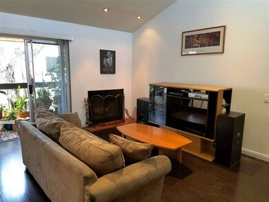 Vaulted ceiling and wood-burning fireplace in livi