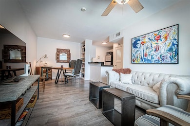 Living area with wood finished floors and a ceili