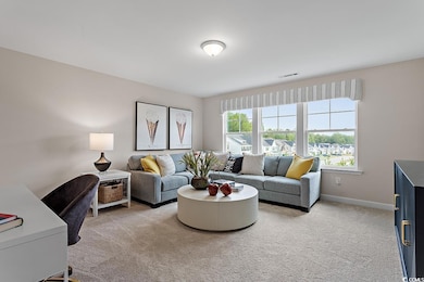 Living area with plenty of natural light and light carpet