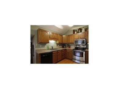 Kitchen. Stainless appliances and oak flooring.