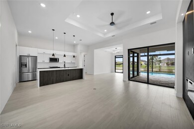 Unfurnished living room featuring a ceiling fan, r