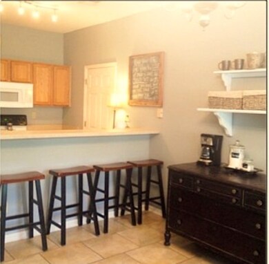 Galley kitchen with breakfast bar that overlook wi
