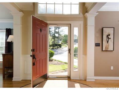 The foyer is flanked by the formal living and dini
