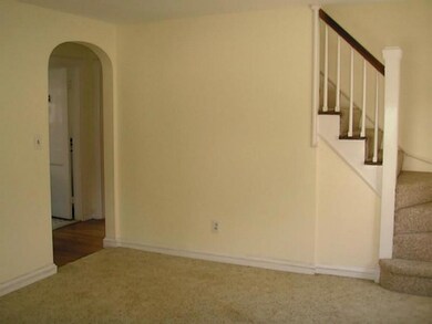 Living Room. Arched doorways and turned staircase