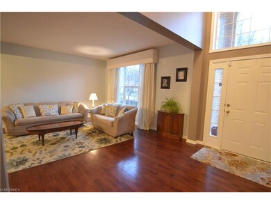 Open living room with hardwood floor and large pic