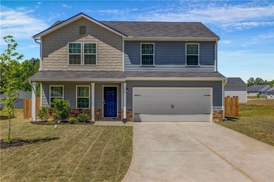 View of front of home featuring driveway, a garage