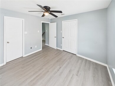 Unfurnished bedroom featuring baseboards, light wo