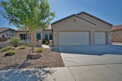 3 car garage with paved side yard