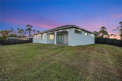 Back of property featuring a fenced backyard, stucco siding, and a patio area