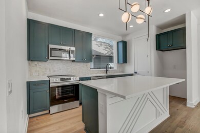 Kitchen with stainless steel appliances, a sink, 