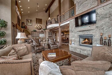 Living room with a towering ceiling, an inviting c