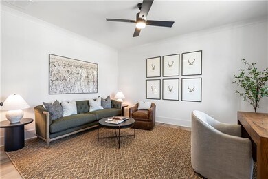 Living area featuring baseboards, crown molding, a