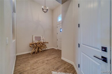 Foyer featuring light wood finished floors, basebo