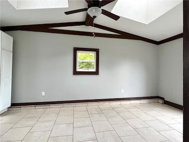Family room featuring vaulted ceiling with skyligh