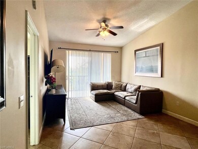 Living room with a textured ceiling, baseboards, c