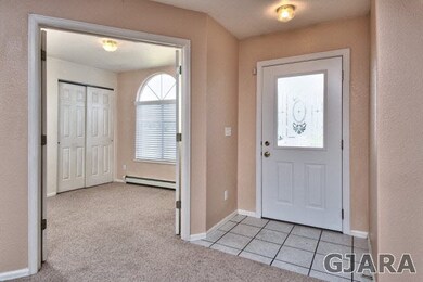 A tiled entryway greets you at the frosted-windowe