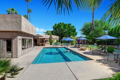 BACK YARD WITH POOL AND LOUNGES