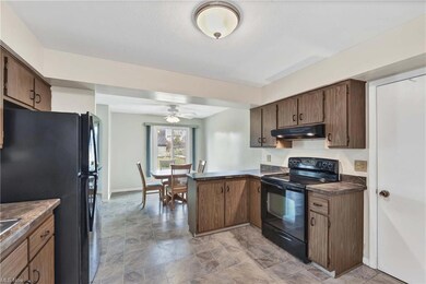 Kitchen with light vinyl floor, kitchen peninsula,