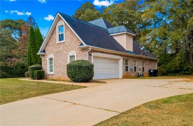 View of home's exterior featuring brick siding, driveway, a garage, a lawn, and a shingled roof