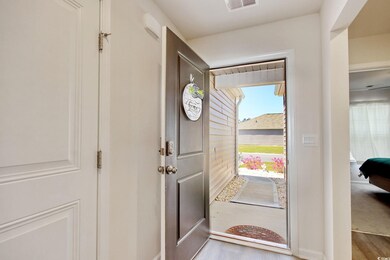 Foyer entrance featuring visible vents and wood fi