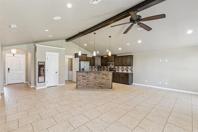 Kitchen featuring beam ceiling, open floor plan, decorative light fixtures, dark brown cabinetry, and recessed lighting