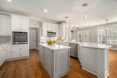 The Updated Kitchen is a dream featuring Marble Countertops, a large Center Island, Breakfast Bar, and Top-of-the-Line Appliances.