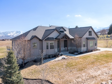 View of front of property with a mountain view, a front lawn, board and batten siding, and roof with shingles