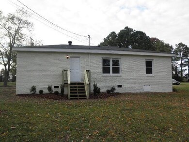 Back of home.  Brick is freshly painted