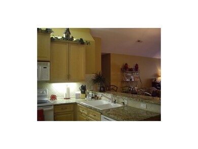 Kitchen has granite counters & breakfast bar.