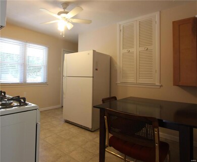 Eat In Kitchen with dishwasher - gas stove.Vinyl flooring with ceiling fans and wood cabinets and a pantry. A man door leads to the wood deck