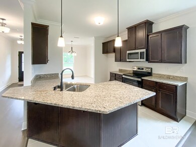 Kitchen with sink, pendant lighting, kitchen peninsula, and stainless steel appliances