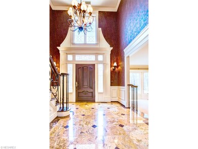 Grand two-story foyer with warm yet striking polis