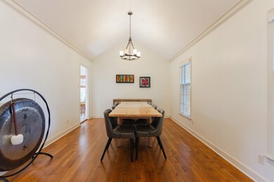 Dining room featuring crown molding, lofted ceilin