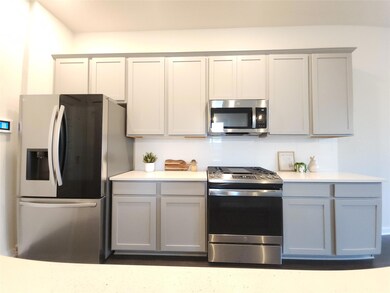 Kitchen featuring appliances with stainless steel