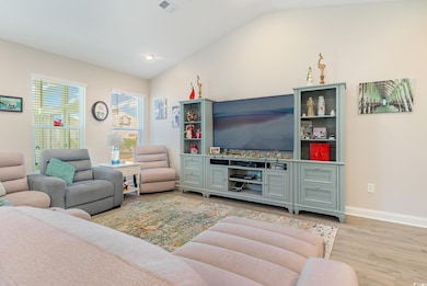 Living room featuring lofted ceiling and light woo