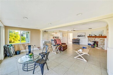 Tiled living room featuring ceiling fan