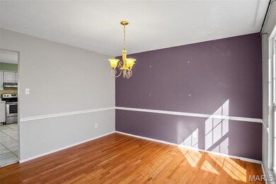 Unfurnished room featuring light wood-style floors and a chandelier