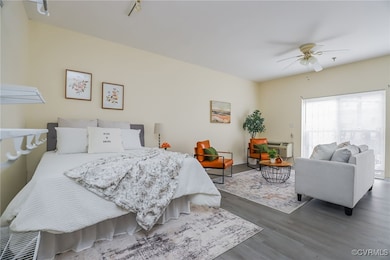 Bedroom featuring ceiling fan and dark hardwood /
